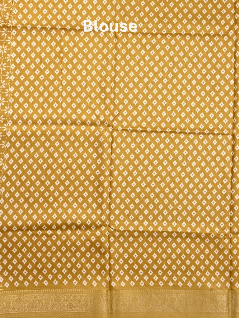 Dola silk fancy saree yellow color allover prints & zari border with printed pallu and printed blouse