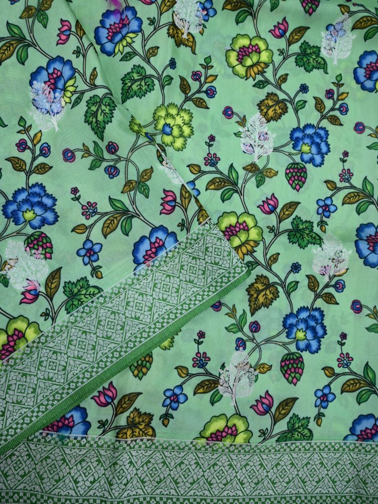 Dola silk fancy saree pista green color allover prints & zari border with short pallu and printed blouse