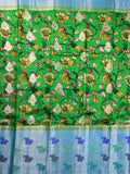 Jute matka fancy saree parrot green color allover prints & big zari border with short pallu and attached brocade blouse