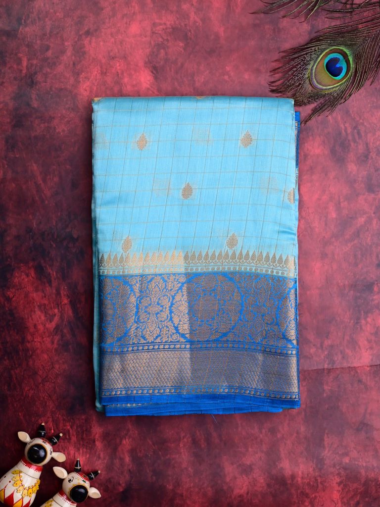 Munga pattu saree light blue color allover checks and zari motifs & zari border with short pallu and contrast brocade blouse