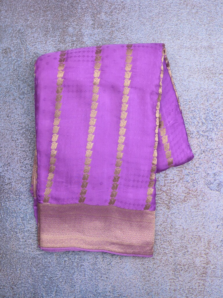 Crape fancy saree purple color allover zari weaves & zari border with zari pallu and plain blouse