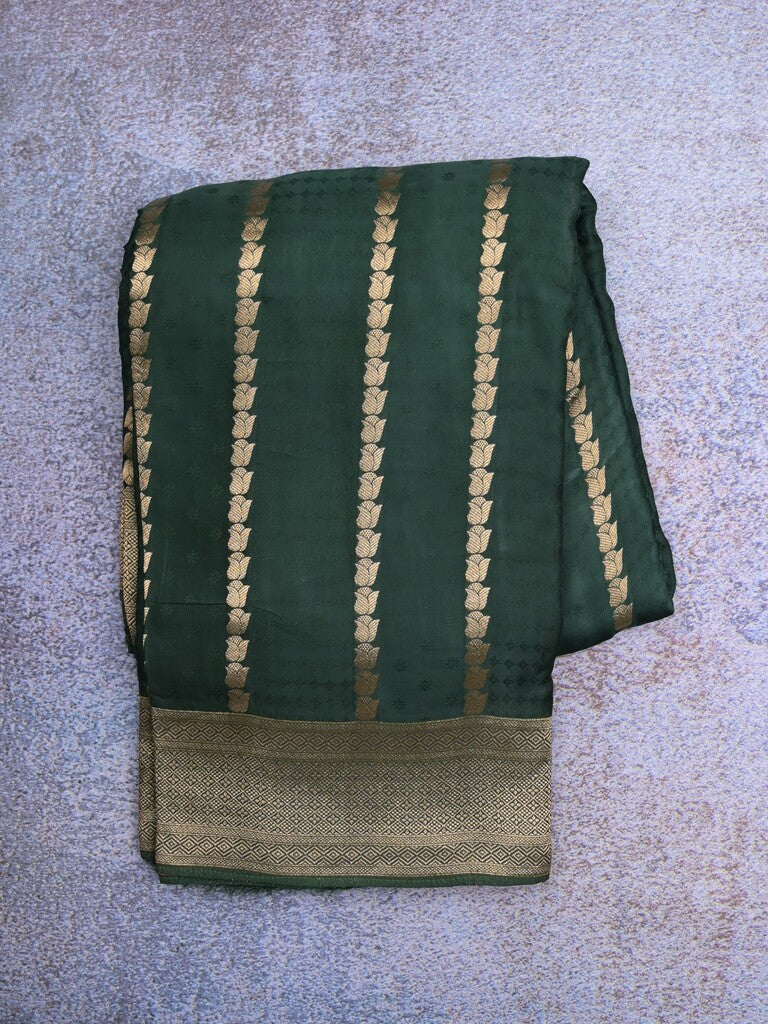 Crape fancy saree dark green color allover zari weaves & zari border with zari pallu and plain blouse