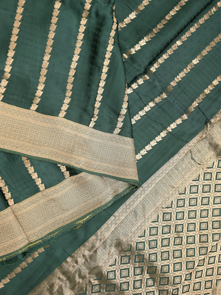 Crape fancy saree dark green color allover zari weaves & zari border with zari pallu and plain blouse