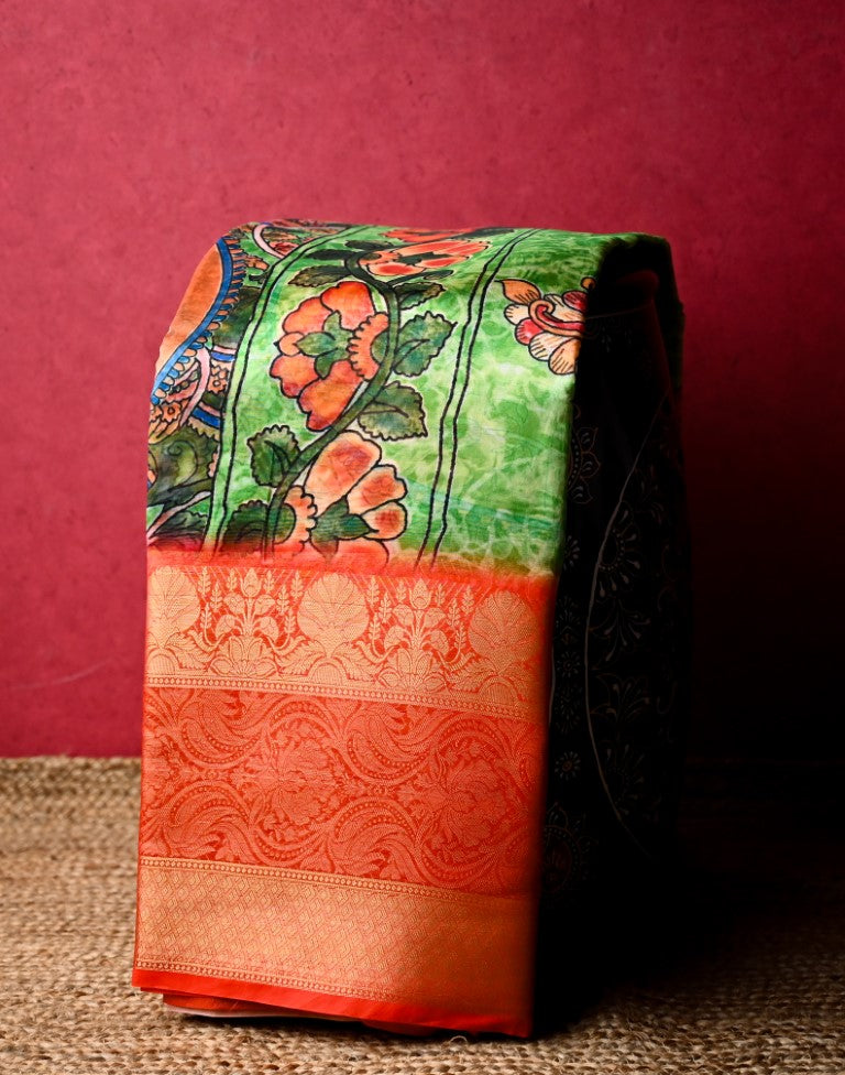 Chiniya silk saree green and orange color with allover digital kalamkari prints, short pallu, big zari border and plain blouse