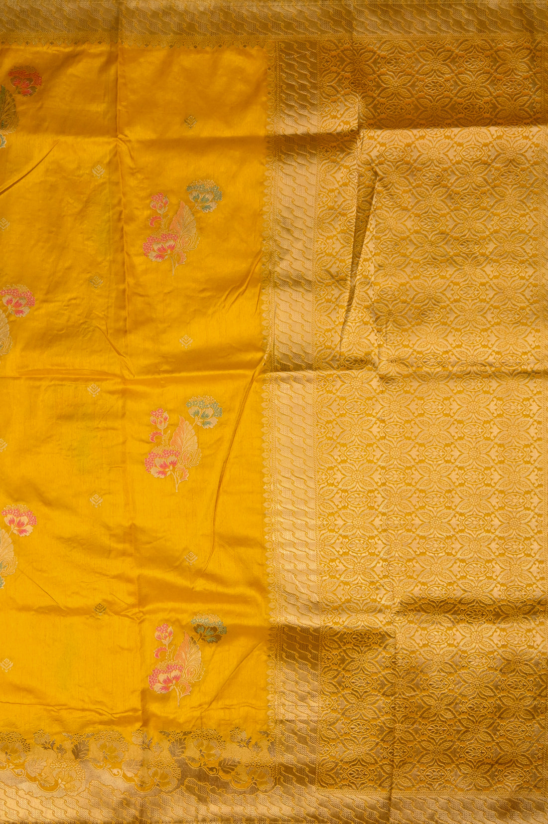 Dola silk saree dark yellow color with allover meenakari motives, rich pallu, small zari border and running plain blouse.