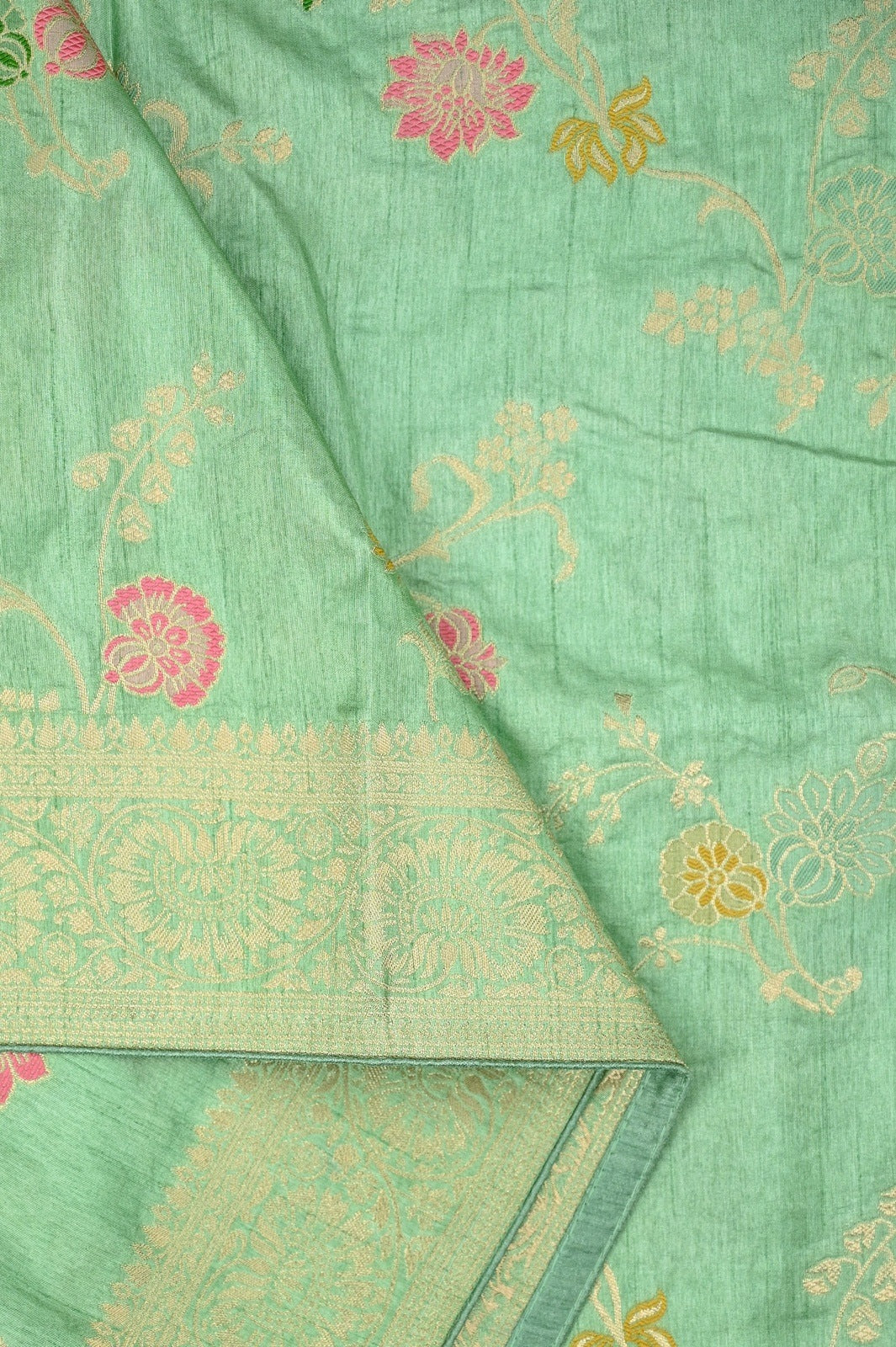 Dola silk saree light green color with allover zari work, rich pallu, small zari border and running plain blouse.