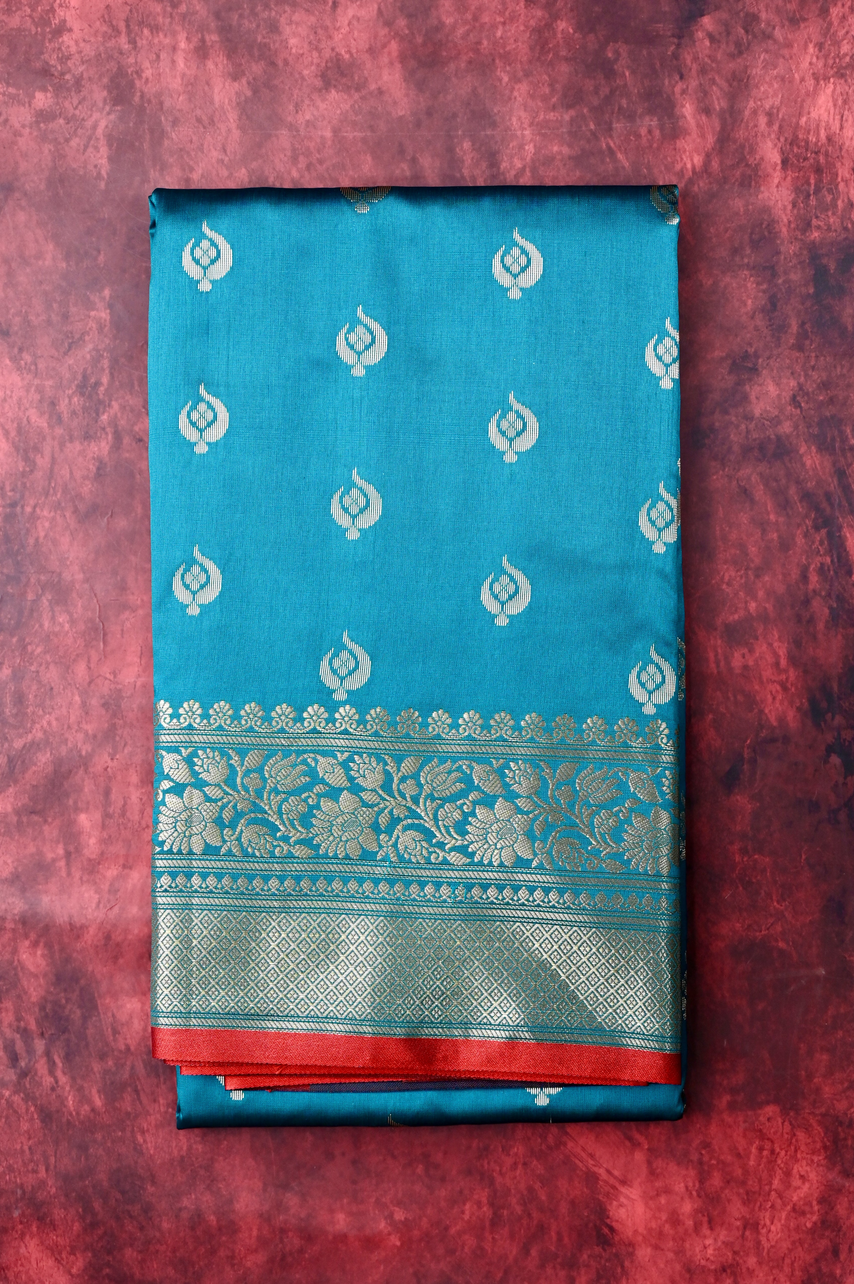 Banaras saree peacock blue color with allover zari motive weaves, contrast pallu, big zari border and plain blouse.