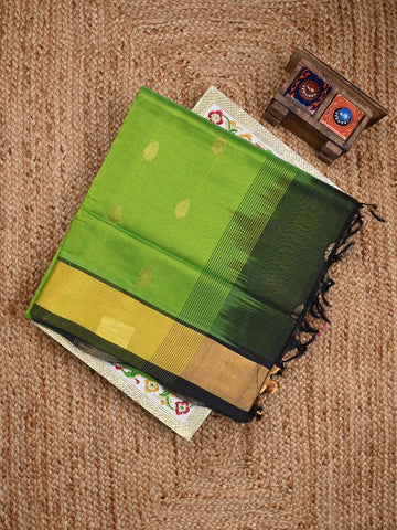 Uppada seiko pattu saree parrot green color allover zari motifs & kaddi border with zari contrast pallu and attached plain blouse