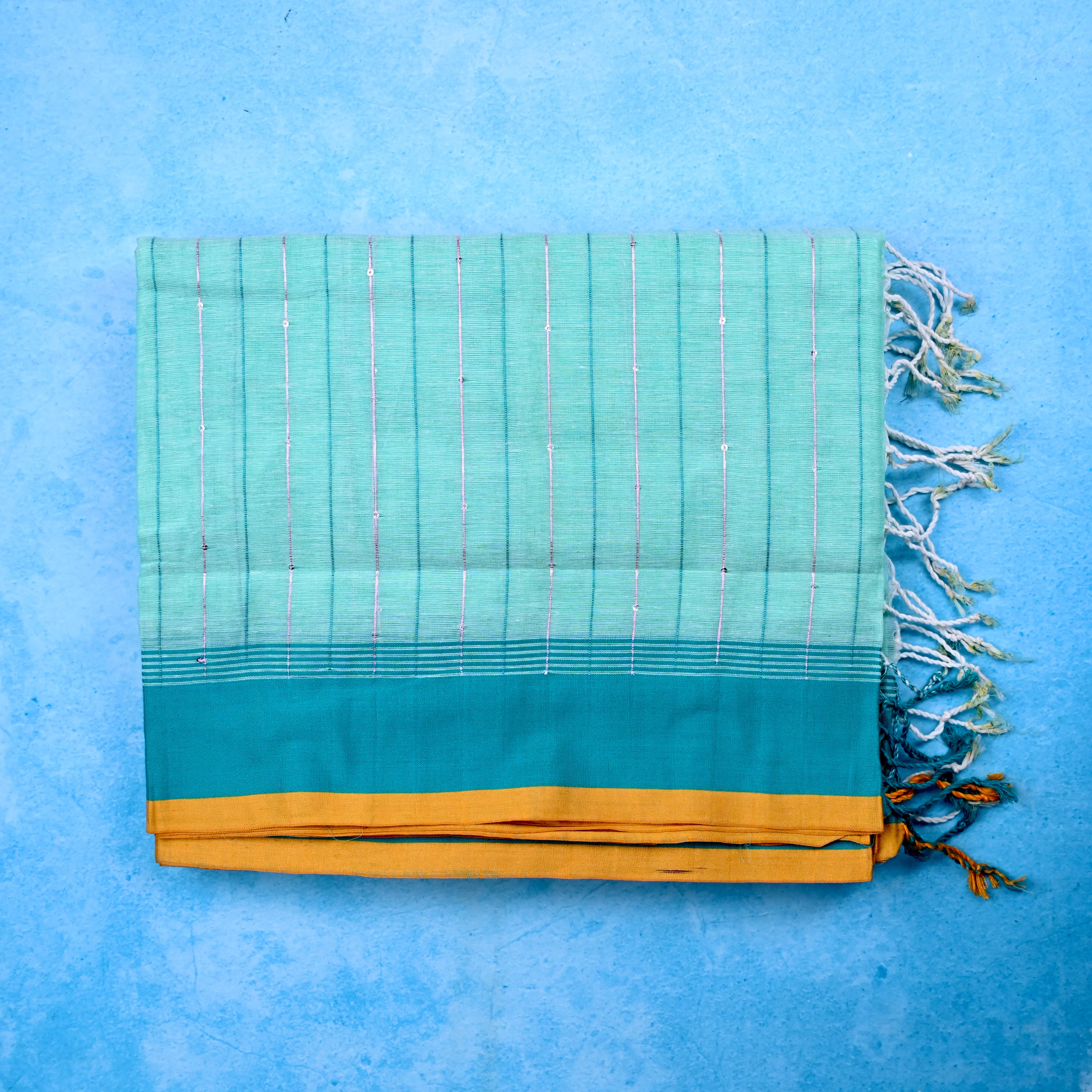 Jute cotton saree sea blue color with all over thread lines with sequence, big pallu, small contrast border and plain blouse.