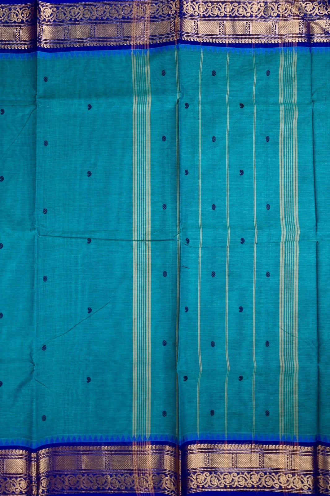 Kanchi cotton saree rama blue color with motives, running pallu, big zari border and plain blouse.