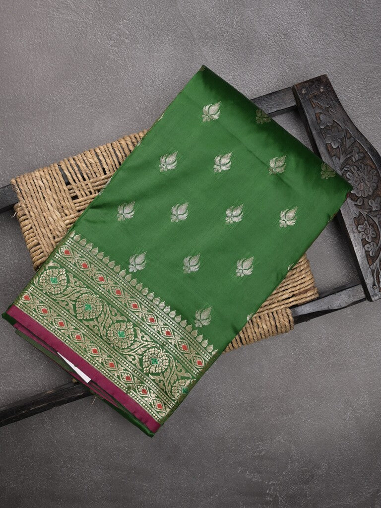 Banaras fancy saree bottle green color allover zari motifs & zari border with rich pallu and contrast plain blouse