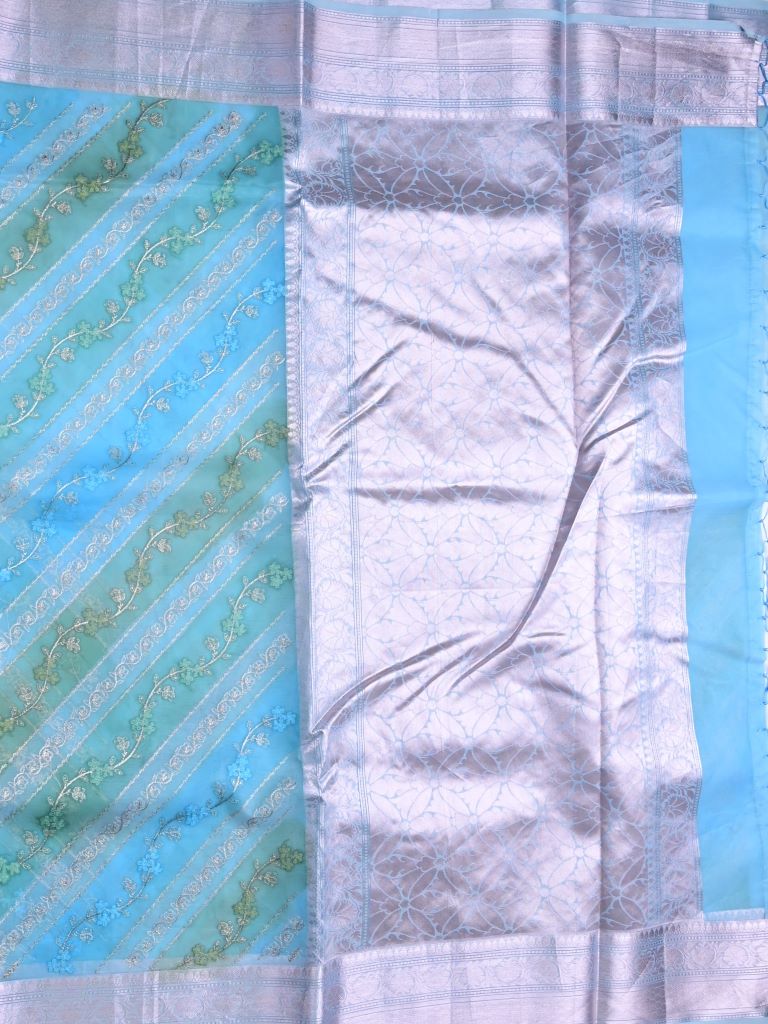 Organza fancy saree sky blue color allover embroidery & zari border with short zari pallu and attached plain blouse