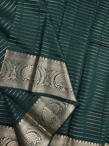 Dupion fancy saree bottle green color allover zari stripes & zari weaving border with rich pallu and brocade blouse