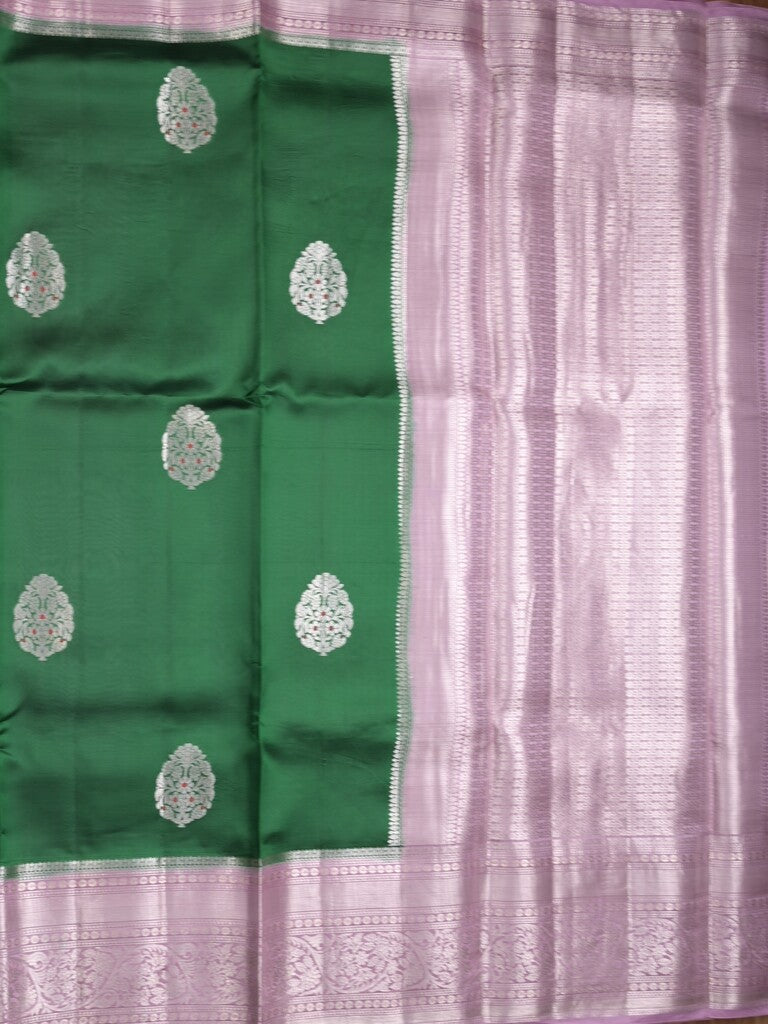 Raw mango pattu saree bottle green color allover zari weaves & zari border with brocade pallu and contrast blouse