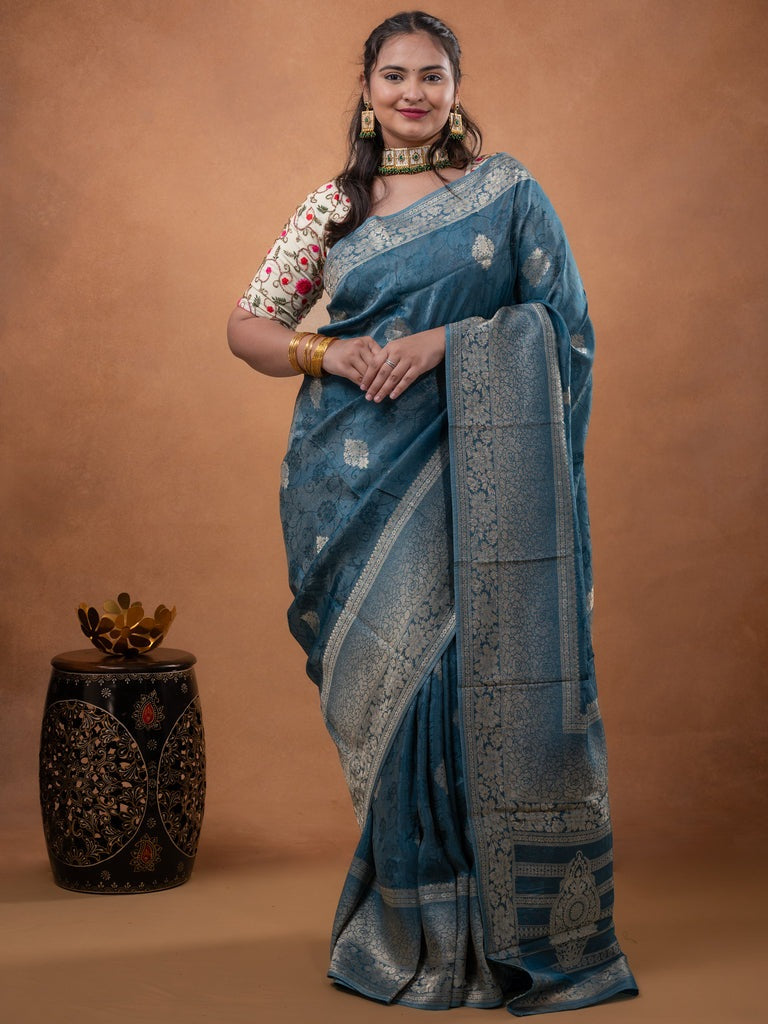 Dola tissue fancy saree light blue color allover zari motifs & zari border with rich pallu and plain self blouse