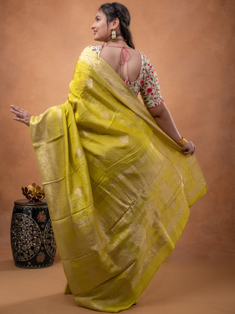 Dola tissue fancy saree lemon yellow color allover zari motifs & zari border with rich pallu and plain self blouse