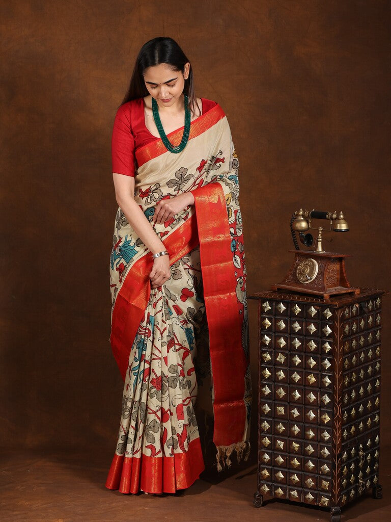 Pen kalamkari pattu saree in cream color with contrast zari border and printed pallu & attached blouse