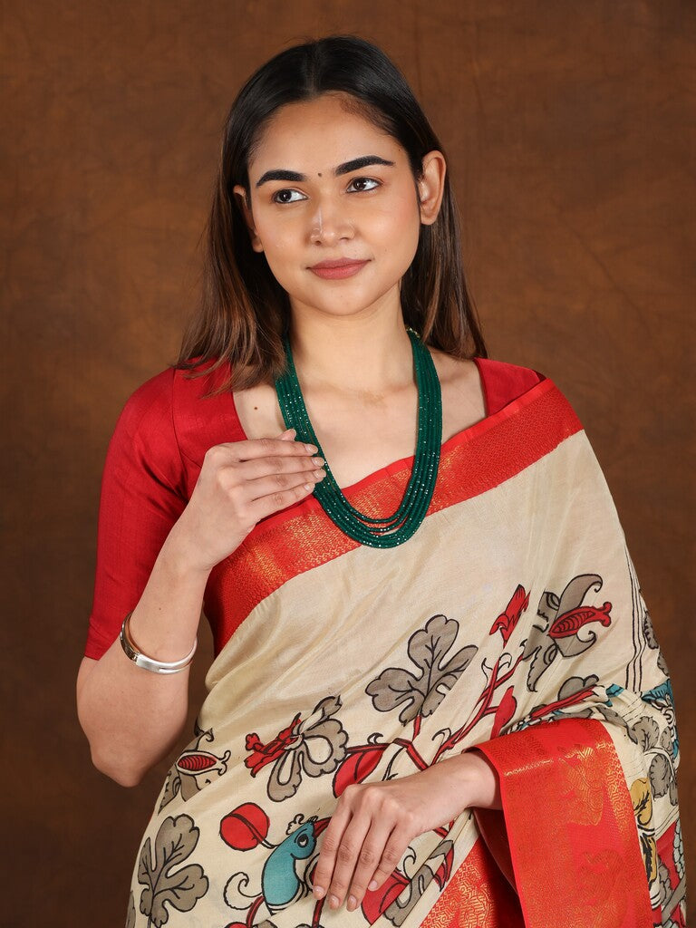 Pen kalamkari pattu saree in cream color with contrast zari border and printed pallu & attached blouse