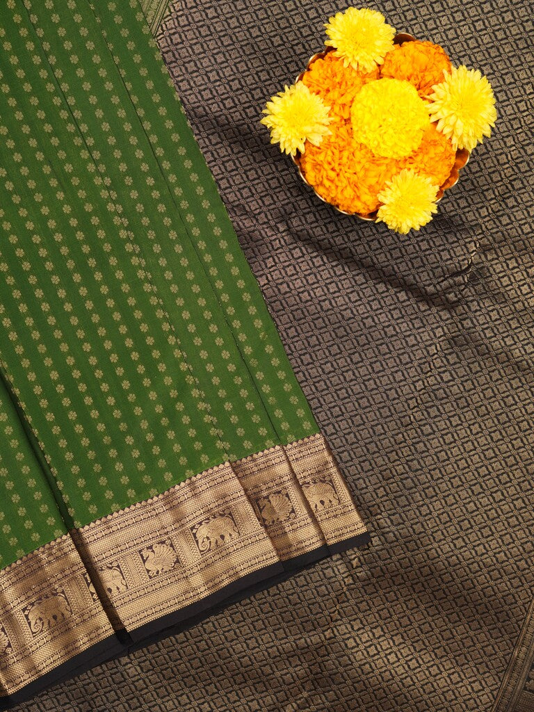 Kanchi pattu saree bottle green color allover zari motifs & zari border with rich pallu and contrast plain blouse