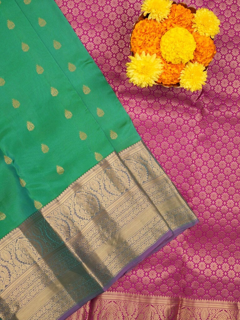 Kanchi pattu saree peacock green color allover zari motifs & kanchi border with rich pallu and contrast plain blouse