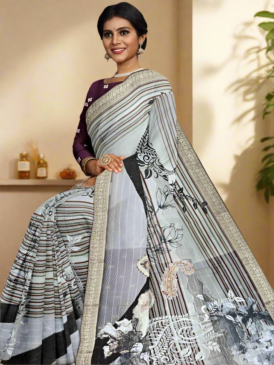 Chiffon fancy saree half white color allover stripes, prints and sequence work & zari border with short pallu and attached blouse