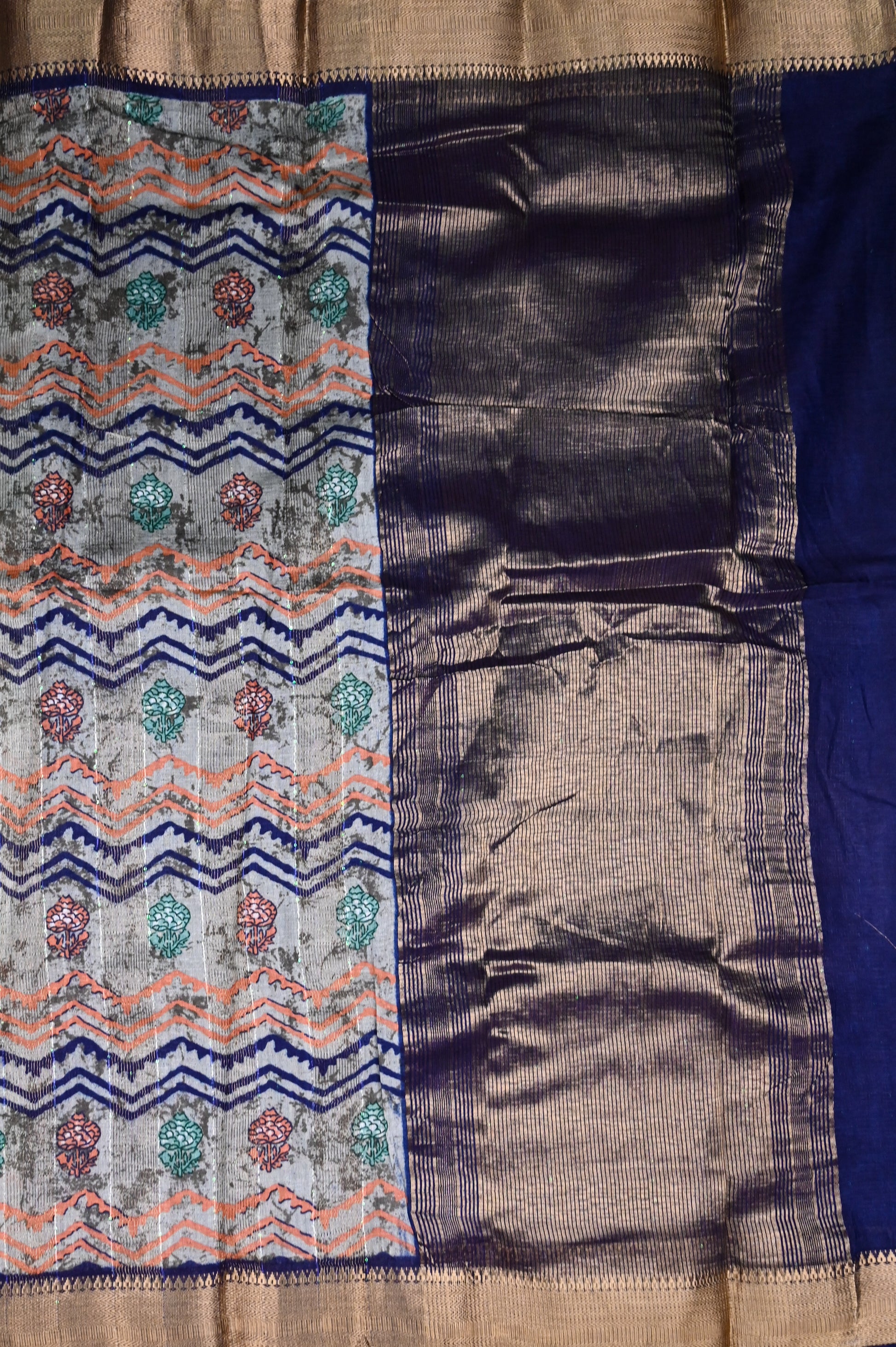 Jute fancy saree grey color with allover prints, short pallu, small gold zari kaddi border and contrast blouse