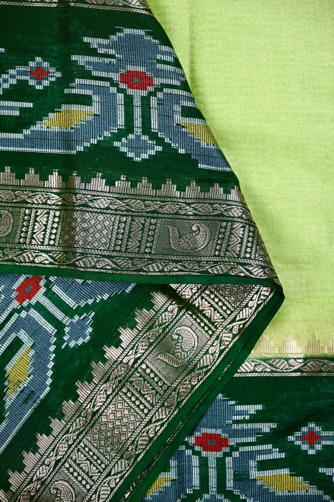 Dupion saree green color with allover zari lines, big printed border and zari border, short pallu and pain blouse.